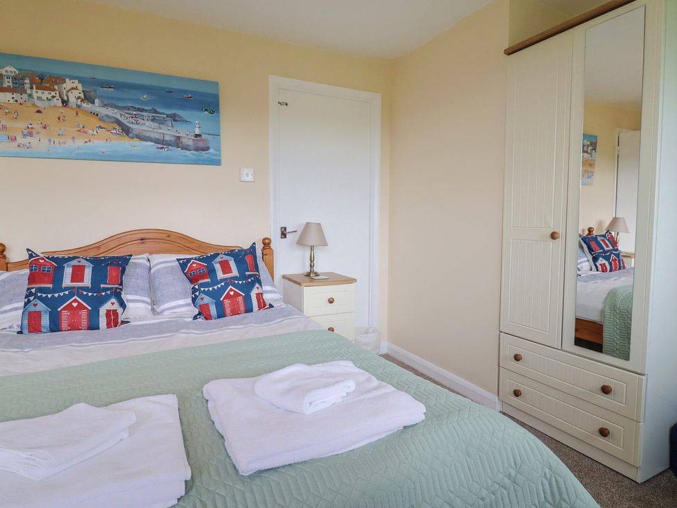 A bedroom with a bed and wardrobe at Court House Farmhouse in Charmouth