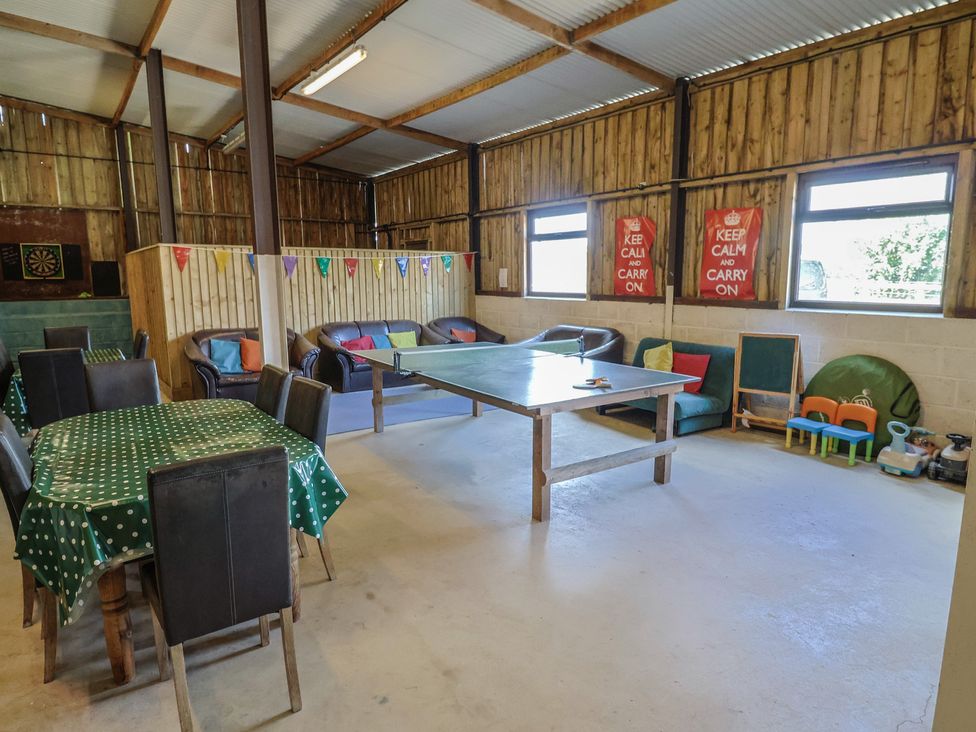 A recreation room with a table and chairs at Court House Farmhouse in Charmouth
