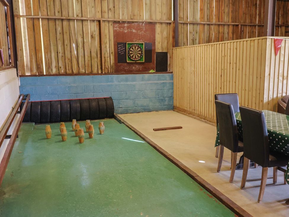 A recreation room with bowling and dartboard at Court House Farmhouse in Charmouth