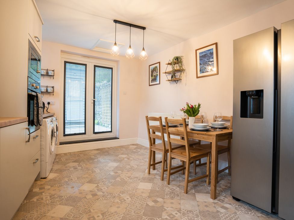 A kitchen with a table and chairs at Garn View in Dolgellau