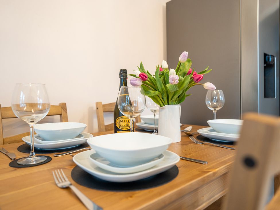 A dining table set with plates and glasses at Garn View in Dolgellau