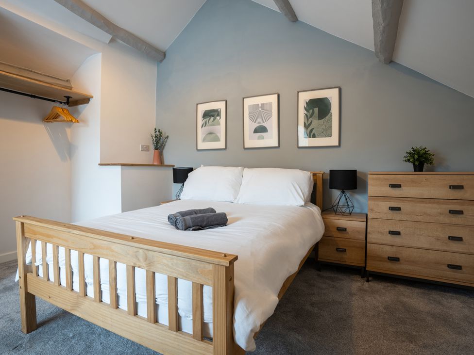 A bedroom with a bed and furniture at Garn View in Dolgellau