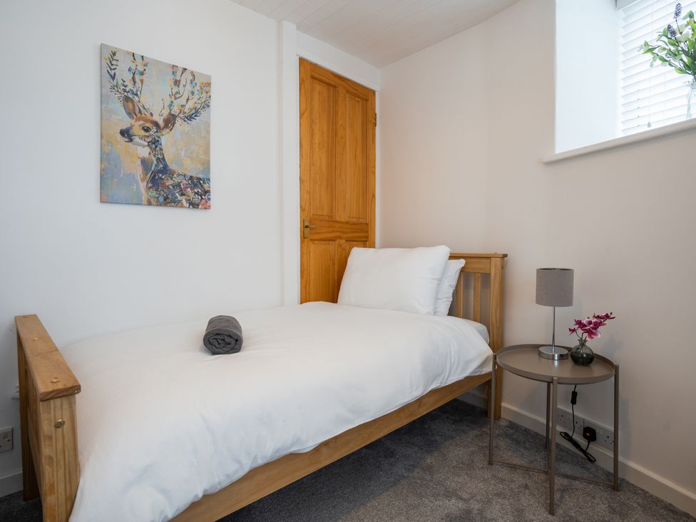 A bedroom with a single bed and side table at Garn View in Dolgellau