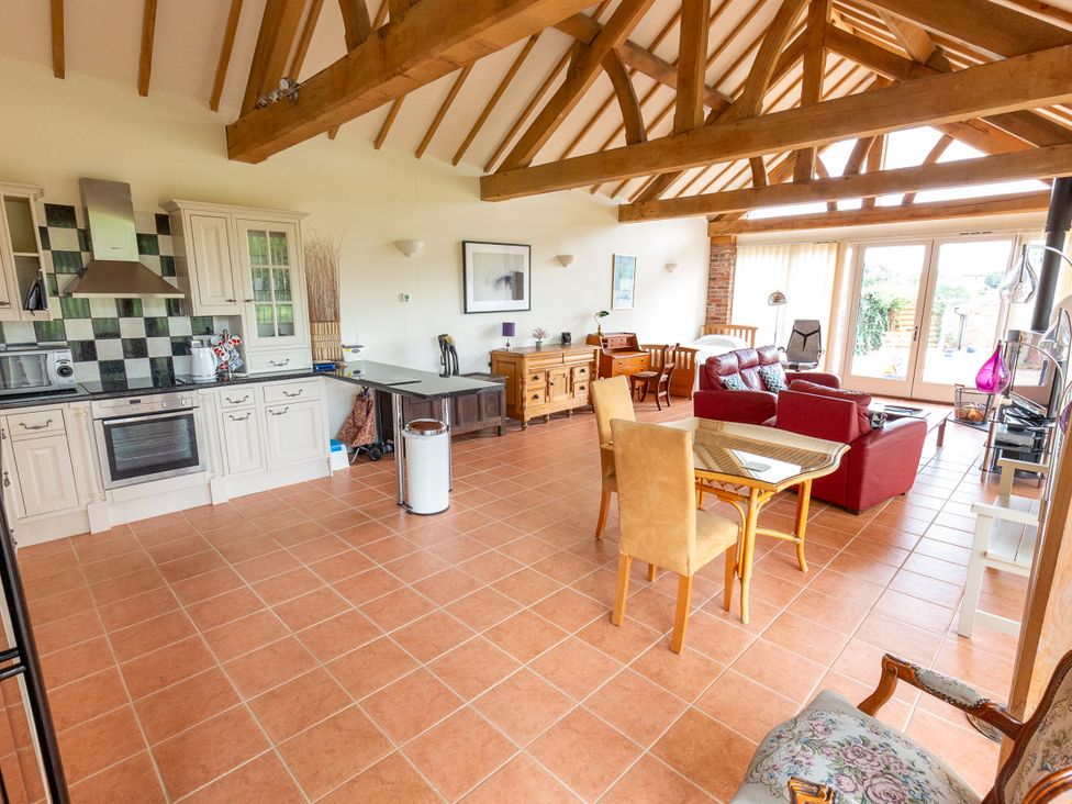 A living room with a kitchen area and furniture at Nature's Lodge in Kidderminster