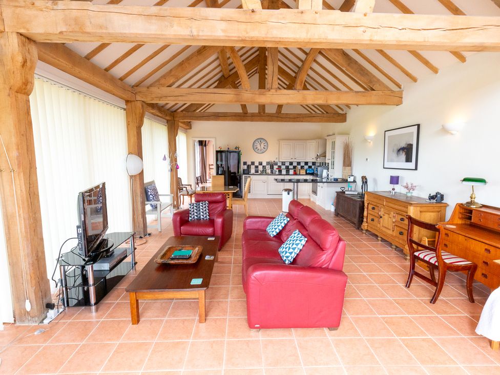 A living room with a sofa and television at Nature's Lodge in Kidderminster