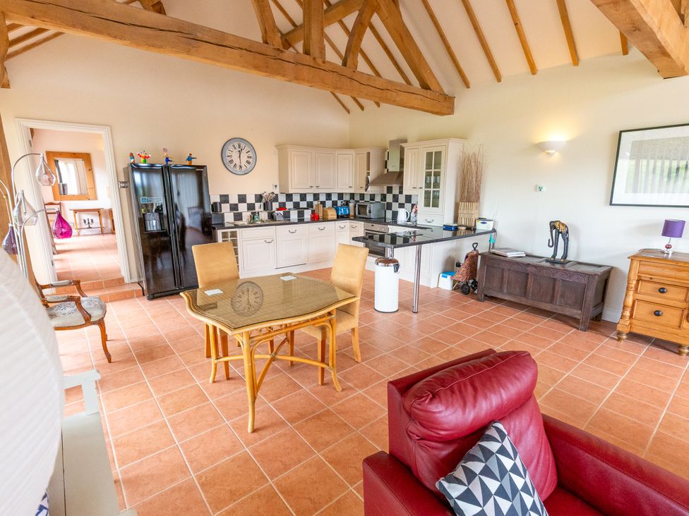 A kitchen with dining area and appliances at Nature's Lodge in Kidderminster