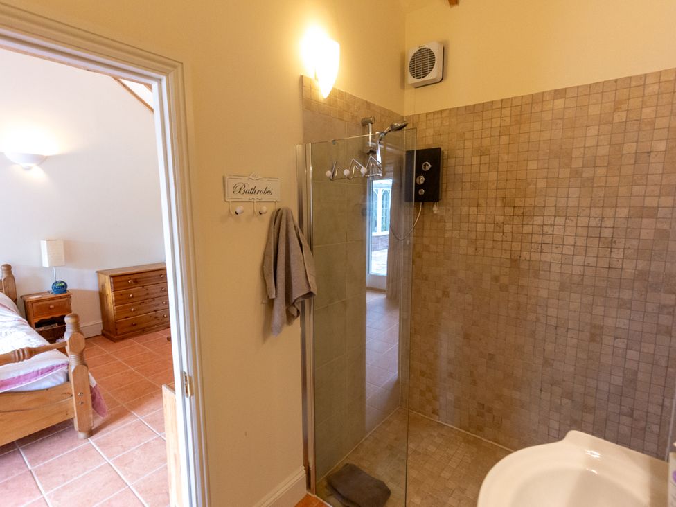 A bathroom with a shower and towel at Nature's Lodge in Kidderminster