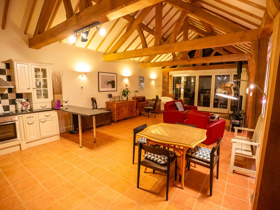 A kitchen with a dining area and seating at Nature's Lodge in Kidderminster