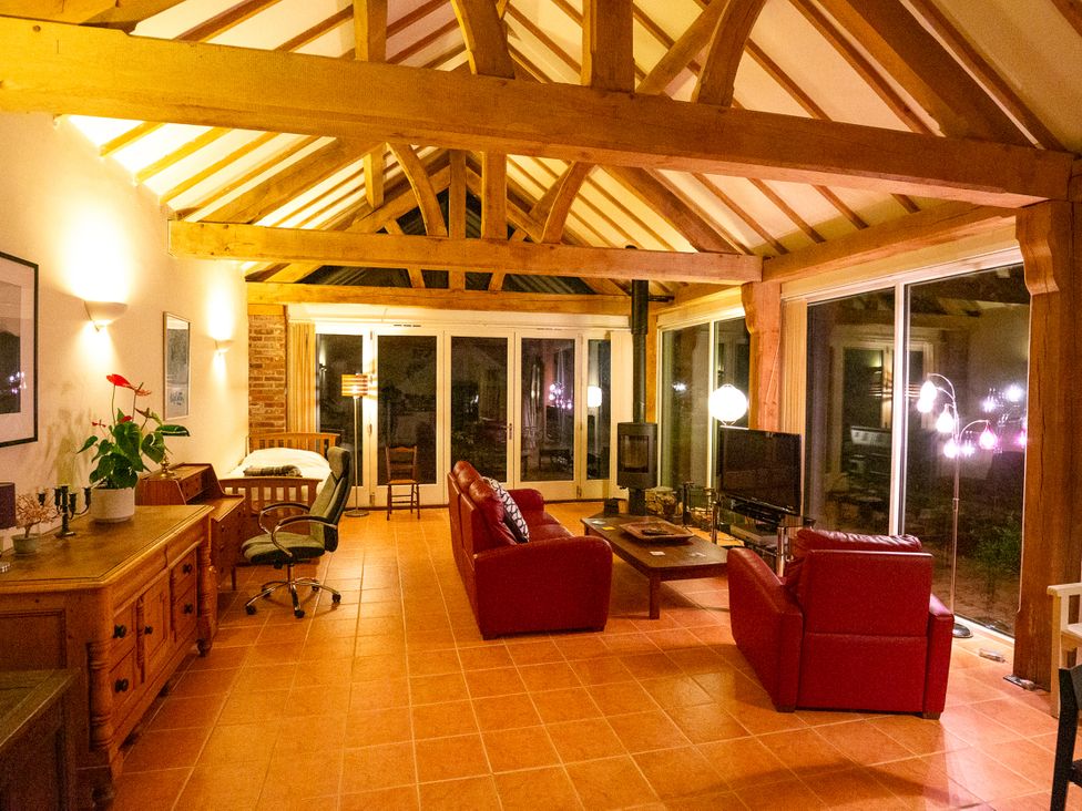 A living room with sofas and a fireplace at Nature's Lodge in Kidderminster