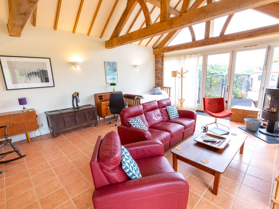 A living room with a sofa and table at Nature's Lodge in Cookley