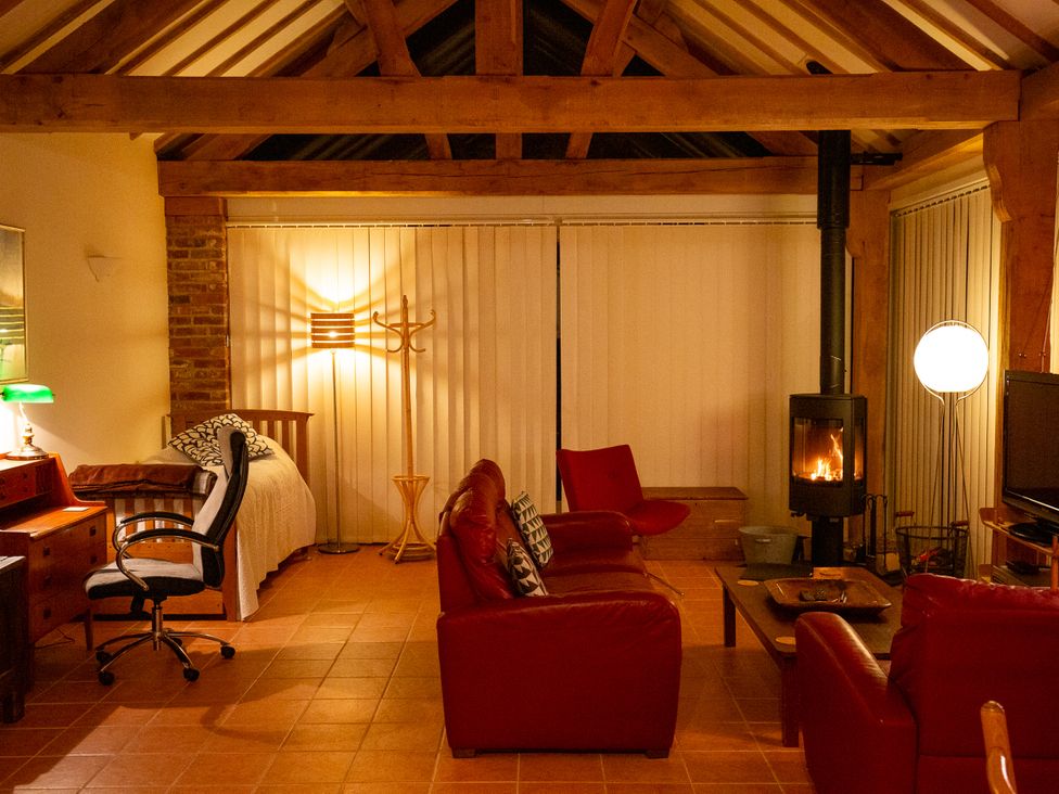 A living room with a sofa and fireplace at Nature's Lodge in Cookley