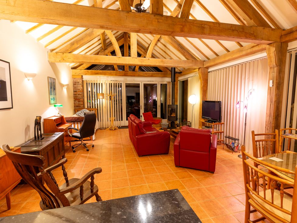 A living room with sofas and a television at Nature's Lodge in Cookley