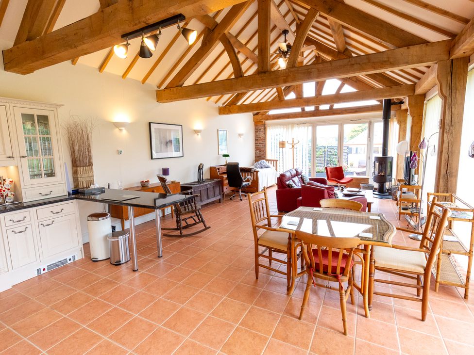 A living room with a table and chairs at Nature's Lodge in Cookley