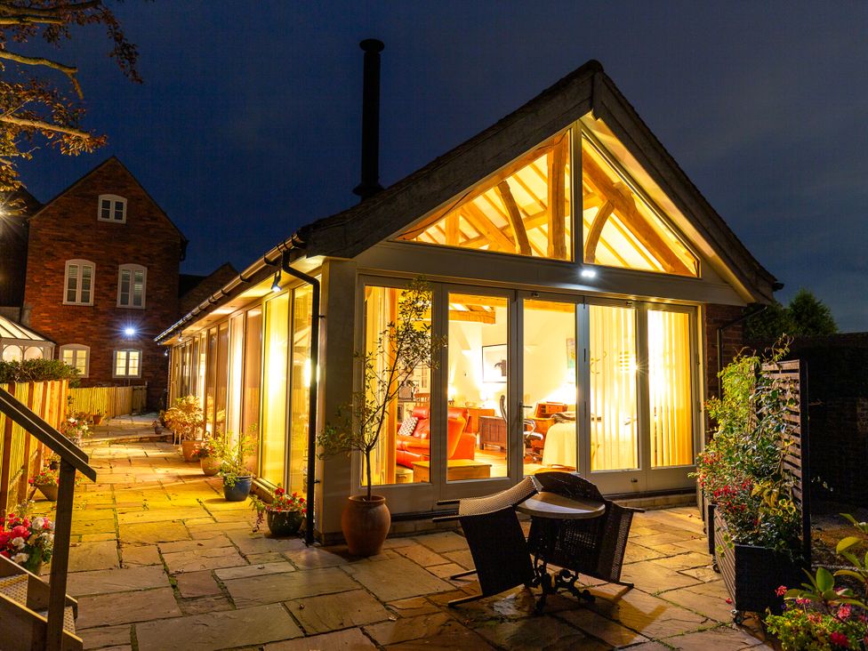 A building with large windows and a pathway at Nature's Lodge in Cookley
