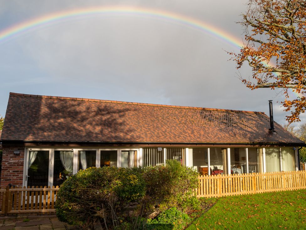 A house with a fence and garden at Nature's Lodge Cookley