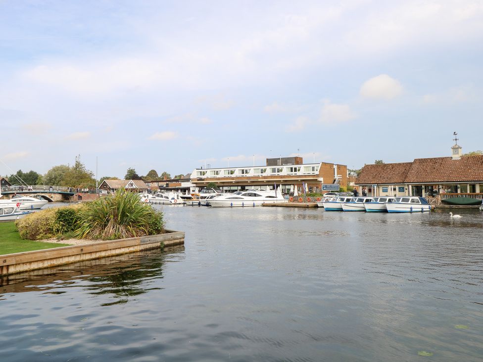 A waterway with boats and a hotel at Cotman Cottage Norwich