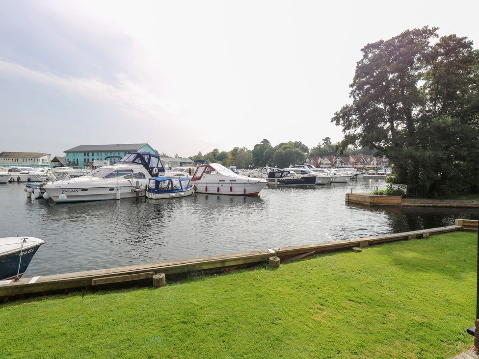 A marina with boats docked and grassy area at Cotman Cottage in Norwich