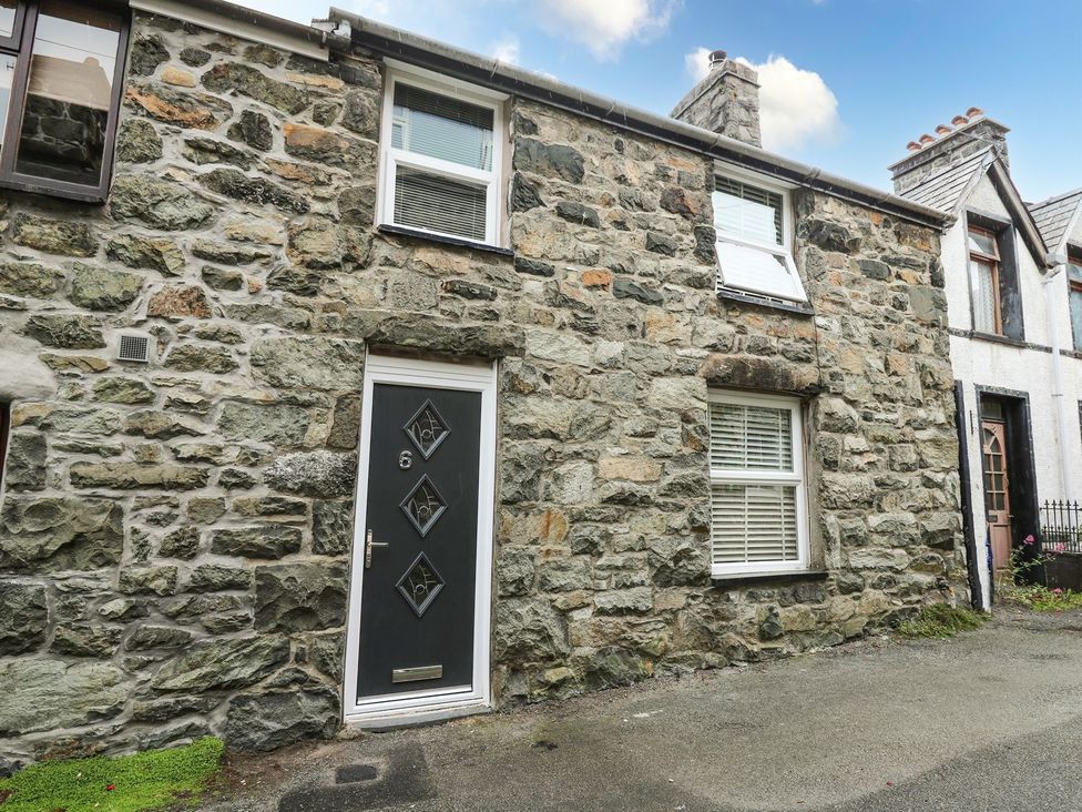 A stone wall with a front door and windows at 6 Upperfield Street in Dolgellau