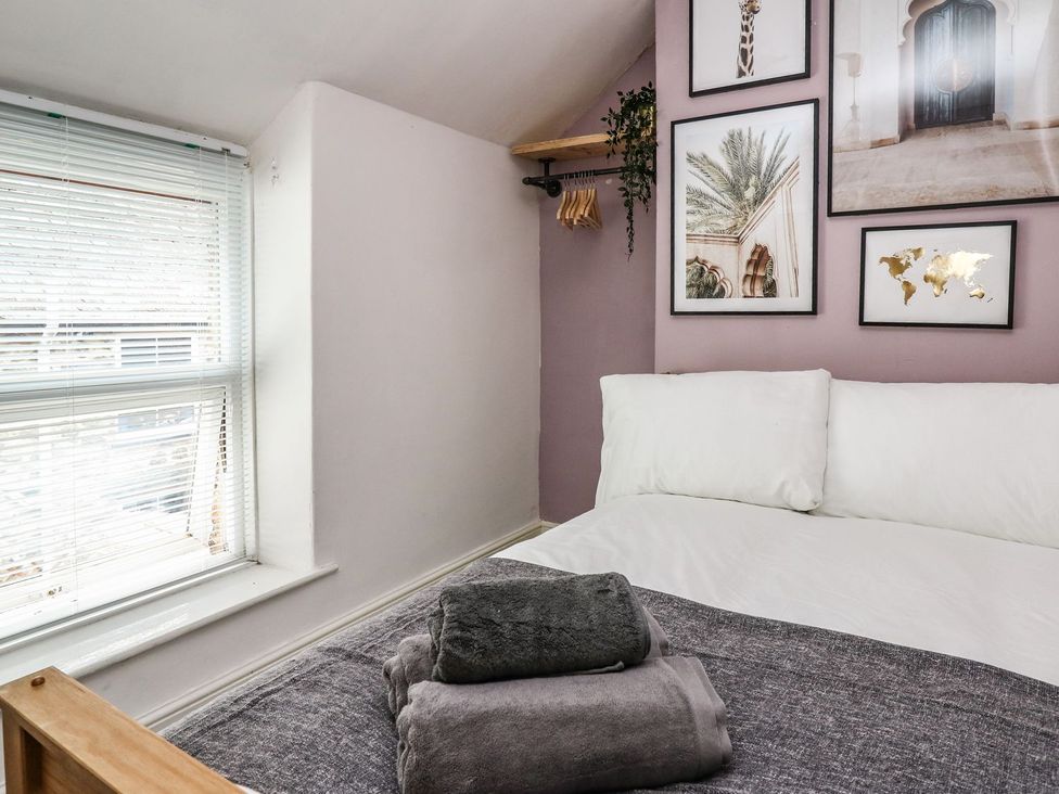 A bedroom with a bed and wall art at 6 Upperfield Street in Dolgellau