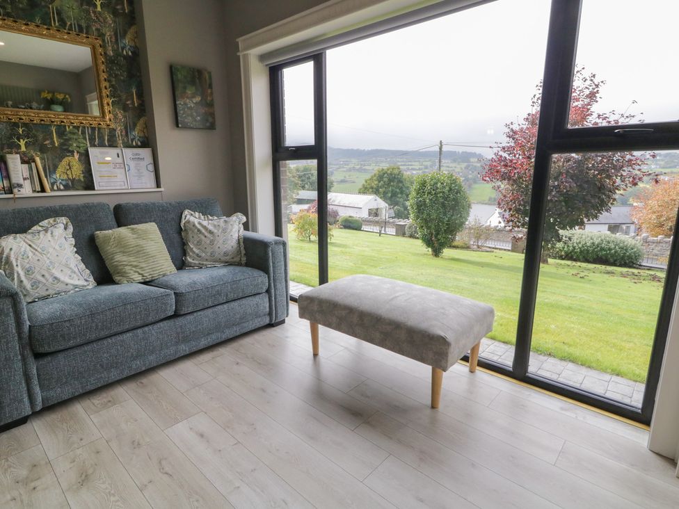 A living room with a sofa and footrest at Lake view House Apartment