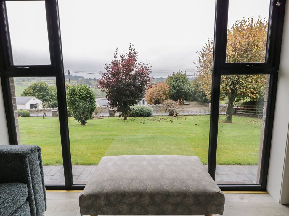 A living room with a view of trees and grass at Lake view House Apartment