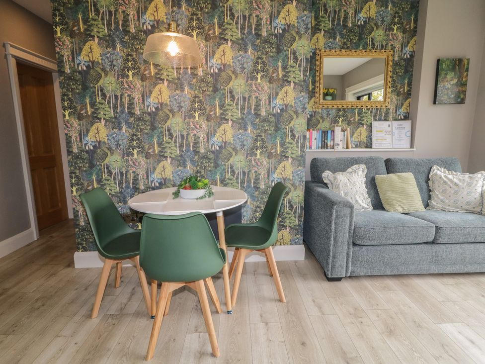 A living room with a table and chairs at Lake view House Apartment
