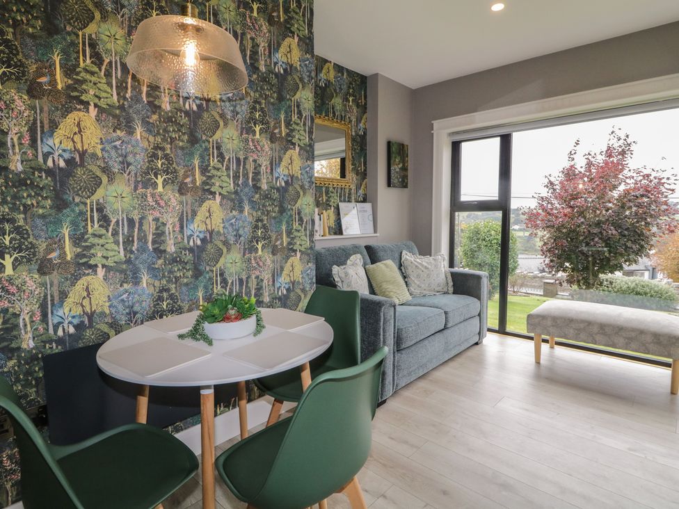 A living room with a table and chairs at Lake view House Apartment