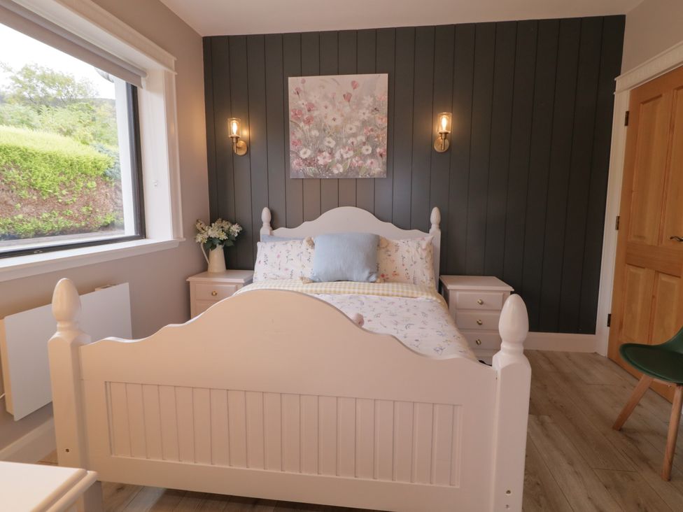 A bedroom with a bed and nightstand at Lake view House Apartment