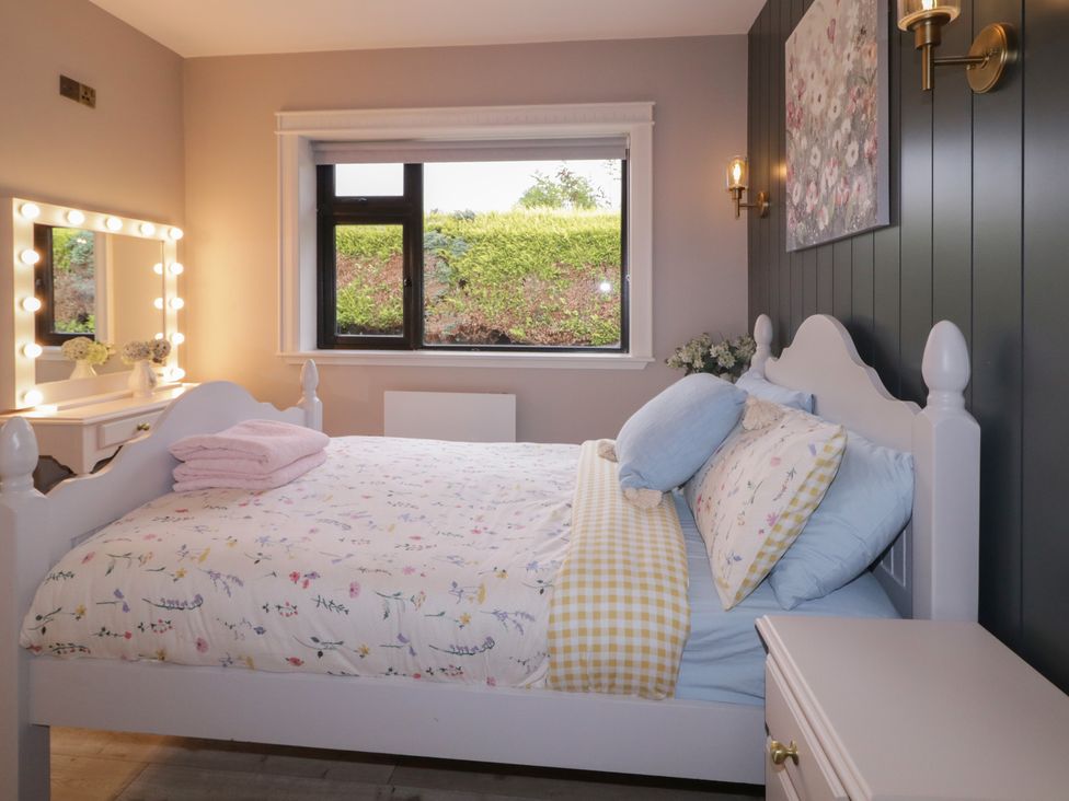 A bedroom with a bed and dresser at Lake view House Apartment