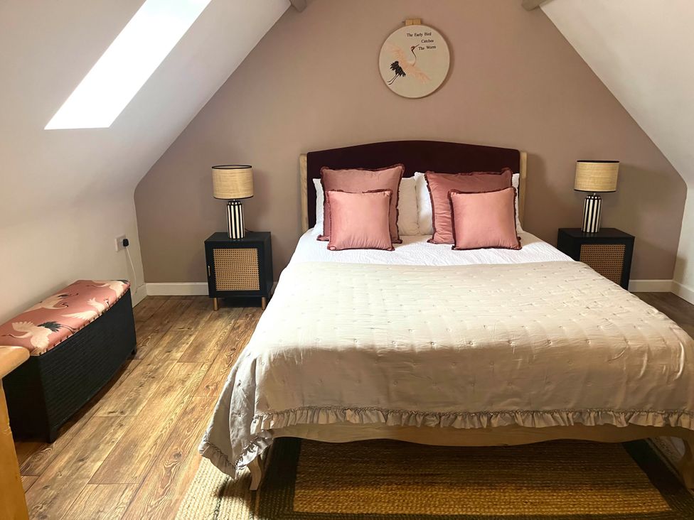 A bedroom with a bed and lamps at Foxley Lodge in Norwich