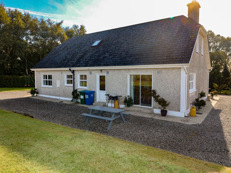 A house with a table and chairs outside at The Lodge Bolinahaney Bunclody, County Wexford