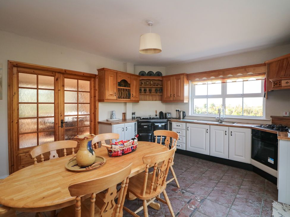 A kitchen with dining table and chairs at The Lodge Bolinahaney Bunclody, County Wexford