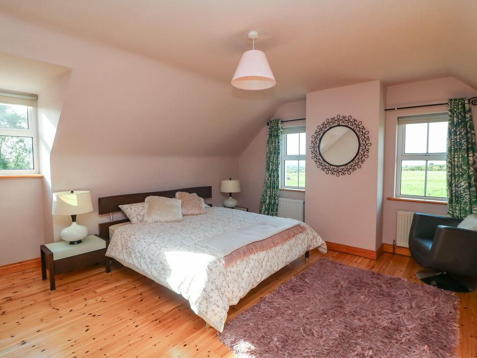 A bedroom with a bed and lamps at The Lodge Bolinahaney Bunclody, County Wexford
