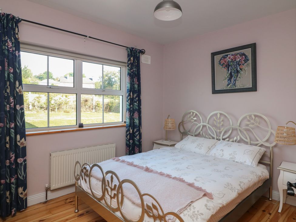 A bedroom with a bed and window at The Lodge Bolinahaney Bunclody, County Wexford