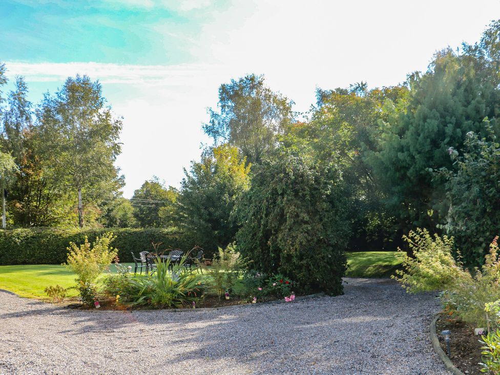 A garden with a gravel path and outdoor furniture at The Lodge Bolinahaney, Bunclody, County Wexford