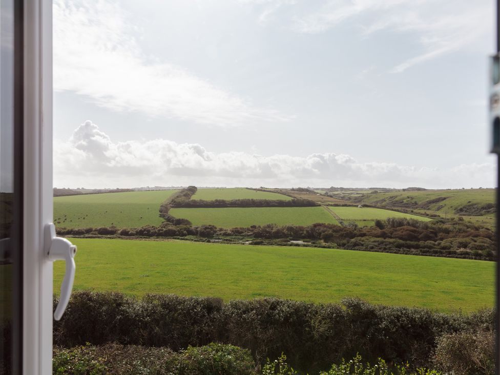 A view of fields and clouds from a window at Polview in Newquay