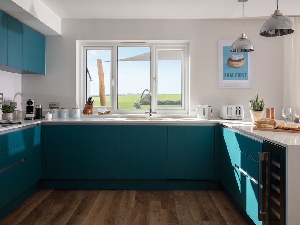 A kitchen with cabinets and appliances at Polview in Newquay