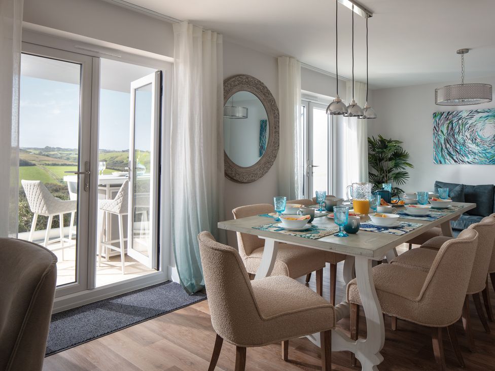 A dining room with a table and chairs at Polview Newquay