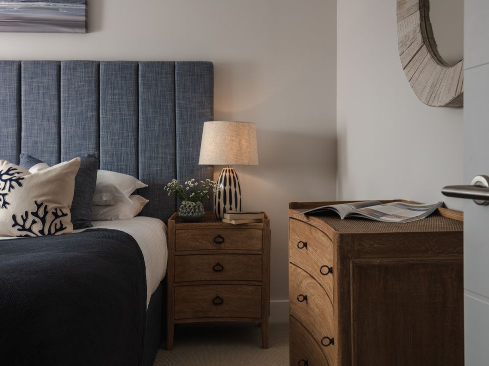 A bedroom with a bed and nightstand at Polview in Newquay