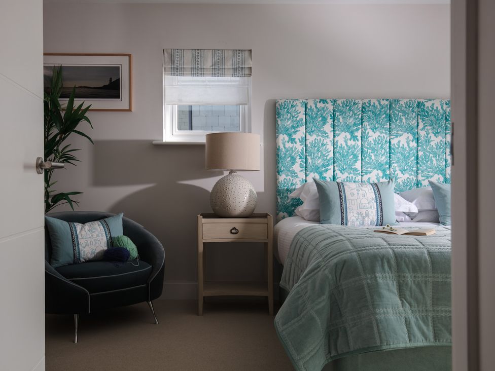 A bedroom with a bed and bedside table at Polview in Newquay