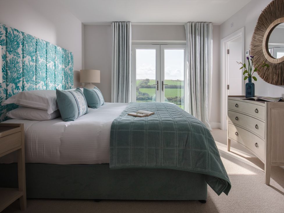 A bedroom with a bed and view at Polview in Newquay