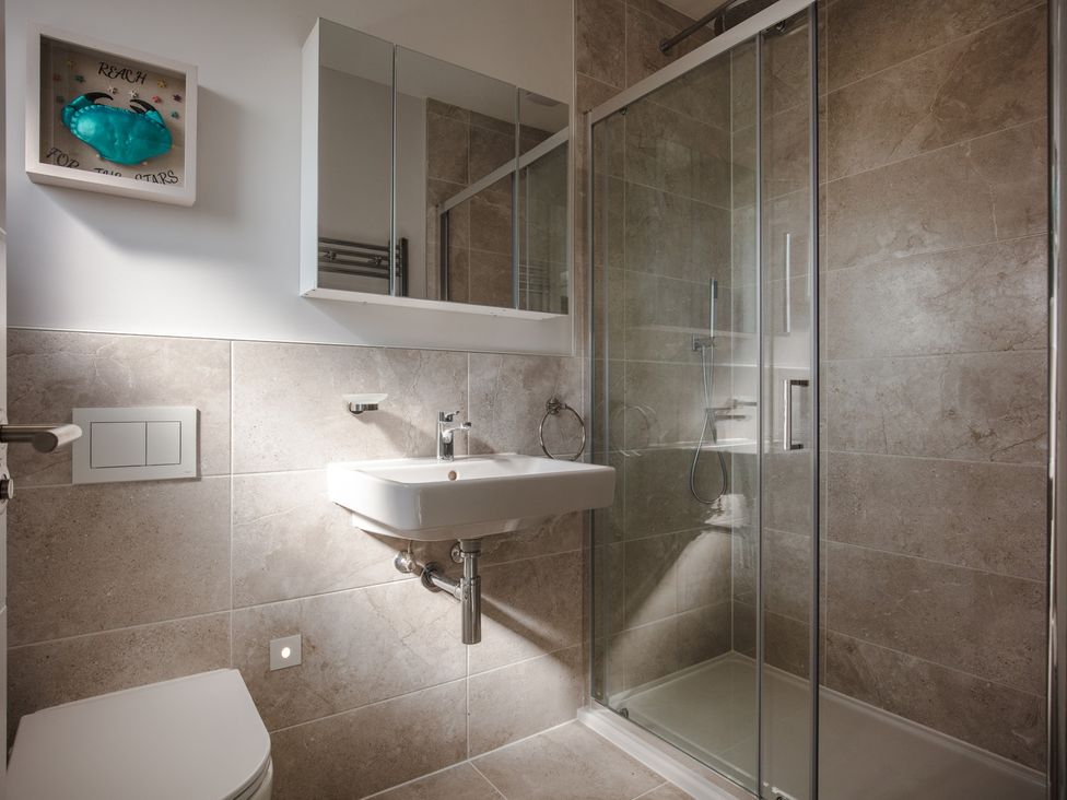 A bathroom with a shower and sink at Polview in Newquay