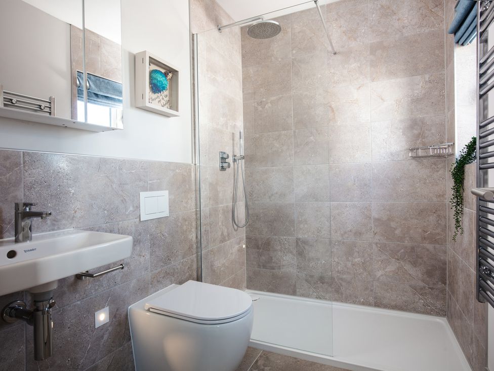 A bathroom with a sink, toilet, and shower at Polview in Newquay