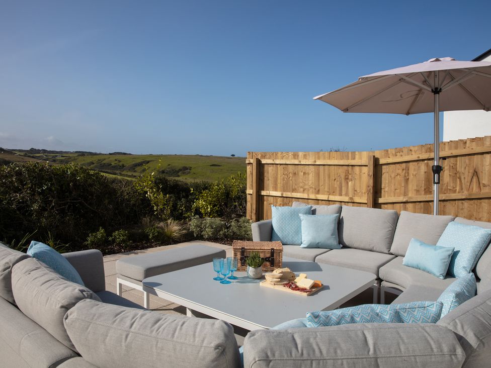 An outdoor area with seating and a table at Polview in Newquay