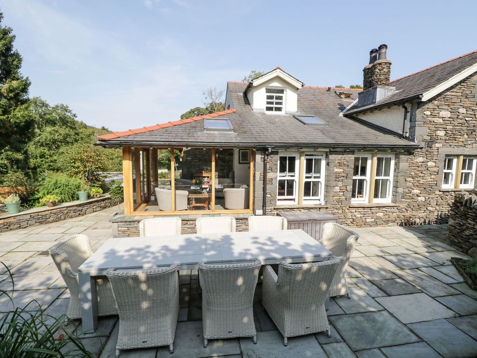An outdoor seating area with a table and chairs at Bobbin Mill Cottage in Ulverston