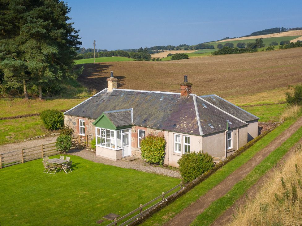A cottage with a garden and pathway at Clayhills Cottage in Blairgowrie