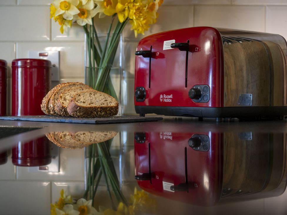 A kitchen with a toaster and sliced bread at Clayhills Cottage Blairgowrie