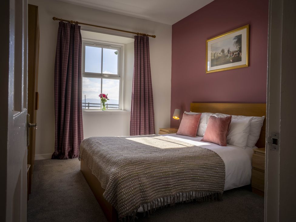 A bedroom with a bed and a window at Clayhills Cottage in Blairgowrie