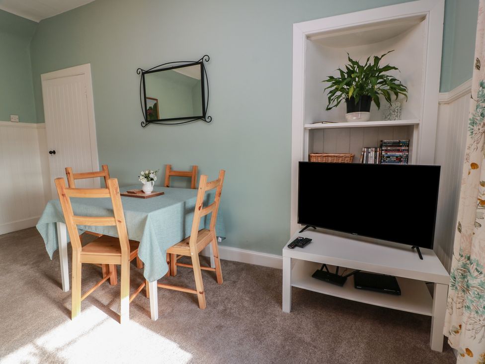 A dining room with a table and chairs at The Bothy in Blairgowrie