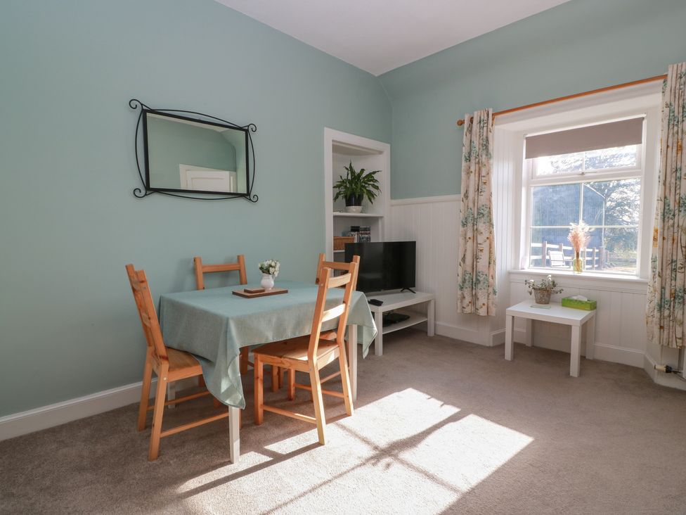 A dining room with a table and chairs at The Bothy in Blairgowrie